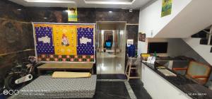 a room with a counter with a rug on the wall at Shree chendur Residency in Tiruvannāmalai +29 photos