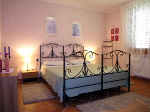 a bedroom with a bed with a wrought iron bed frame at Villino Blu 12 pax villa in Tuscany with private pool in Loro Ciuffenna +64 photos