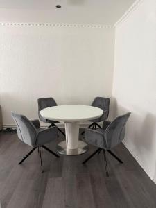 a white table and chairs in a room at Apartament Alex in Mediaş +12 photos