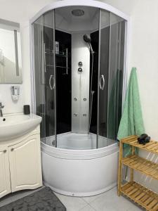 a bathroom with a shower and a sink at Apartament Alex in Mediaş