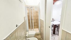 a small bathroom with a toilet and a sink at Jasmine House Ustica heart in Ustica +19 photos