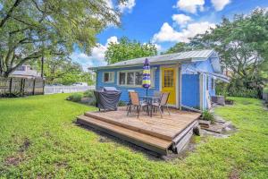 a blue tiny house with a table and chairs on a deck at Blue Reverie - Downtown Cottage in Fort Lauderdale +22 photos