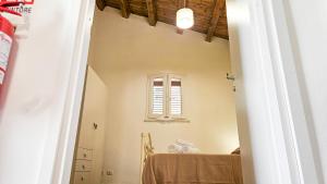 a room with a table and a window at Jasmine House Ustica heart in Ustica