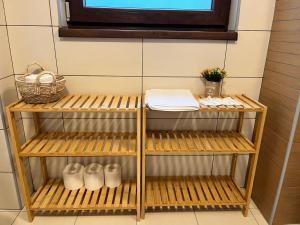 a shelf in a bathroom with white shoes on it at Panorama Pine Retreat - Spacious 2-Bedroom Flat in Predeal +31 photos