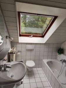 a bathroom with a sink and a toilet and a window at Zimmer mit Weitblick in Weinregion in Bad Kreuznach