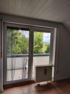 an empty room with two windows and a balcony at Zimmer mit Weitblick in Weinregion in Bad Kreuznach