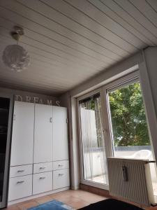 a room with white cabinets and a large window at Zimmer mit Weitblick in Weinregion in Bad Kreuznach