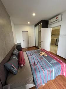 a bedroom with a large bed and a couch at Suite 196 at i-City-2BR l 5 Pax l Wifi l 1 Car Park in Shah Alam +7 photos