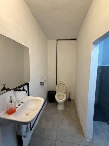 a bathroom with a sink and a toilet at La Embajada Bacalar in Bacalar +16 photos