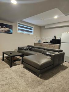 a living room with a couch and a table at Marclyn Homes in Winnipeg