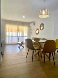 a living room with a dining room table and chairs at Pacifico Beach Front in Málaga