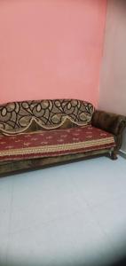 a bench sitting in a room next to a wall at Motimani in Ahmedabad