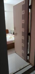 an open door to a bedroom with a bed at Motimani in Ahmedabad