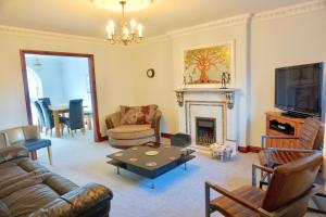 a living room with a couch and a fireplace at The Peak View - Holmfirth in Cartworth