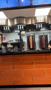 a kitchen with a counter with people preparing food at Facbook in Helsinki