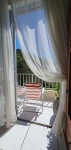 a bench sitting on a porch with a window at Quarto in São José