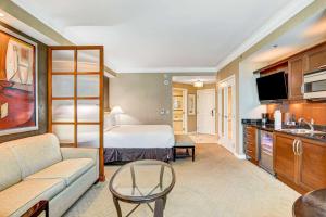 a hotel room with a bed and a couch at Luxurious MGM Strip View 07605 Balcony in Las Vegas