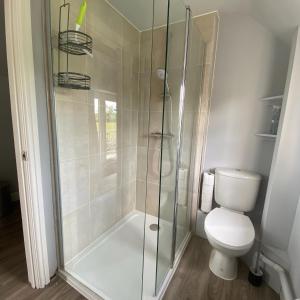 a bathroom with a shower and a toilet at Cold Kitchen View in Longbridge Deverill