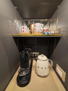 a coffee maker on a shelf in a kitchen at Lary's - San Pietro in Rome +43 photos
