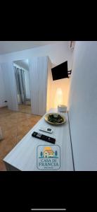 a white counter top with a plate of food on it at Casa Di Francia in Pontedera