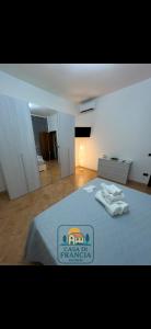 a bedroom with a bed with a blue comforter on it at Casa Di Francia in Pontedera