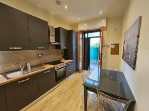 a kitchen with a table and a sink in it at Buildings & Grounds - casa ugo F in Pisa