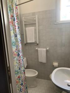 a bathroom with a toilet and a sink at Hotel Migani in Rimini +142 photos