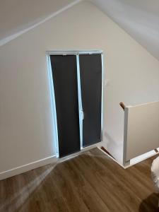 a sliding glass door in a white room at Residence du bois 2 in Mitry-Mory