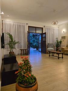 a living room with a couch and a table with flowers at Sprunger Retreat - tulia homes in Moshi