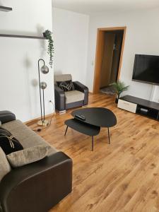a living room with a couch and a table at Ferienwohnung am Bodensee in Tettnang