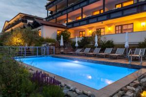 a swimming pool in front of a house at Alpentirolis in Tirolo