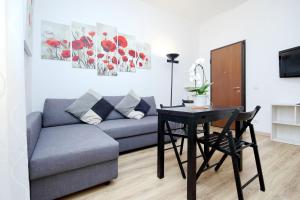 a living room with a couch and a table at Holiday rental San Lorenzo district in Rome