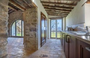 a kitchen with a sink and a stone wall at La Capella in Gubbio +16 photos