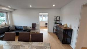 a living room with a couch and a table at Fewo Gerda im schönen Odw in Mörlenbach