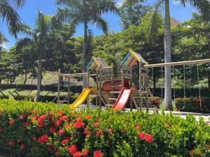 a playground with colorful slides in a park at Apartasol vacacional in Santa Fe de Antioquia