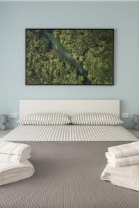 a bedroom with a bed with a painting on the wall at Casa Chanel in Rome