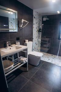 a bathroom with a sink and a toilet and a shower at Mirodil House in Yablunytsya +22 photos