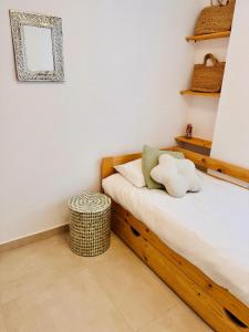 a bedroom with a bed and a table and shelves at MiMar Jávea in Jávea