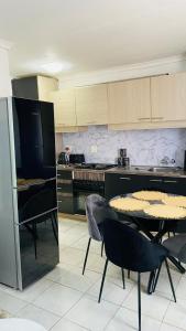 a kitchen with a table and chairs in a kitchen at Prestige suite in Maseru
