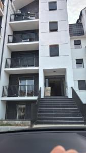 a building with stairs in front of a building at Luxury penthouse apartments in Mladenovac