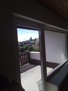 a sliding glass door with a view of a balcony at Wellness und Wander Oase Burgwald 