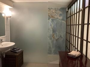 a bathroom with a sink and a mirror and a sink at B&B Matin Tranquille in Liège +71 photos
