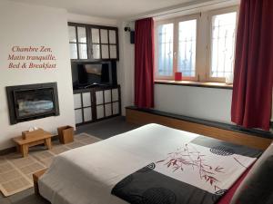 a bedroom with a bed and a fireplace at B&B Matin Tranquille in Liège