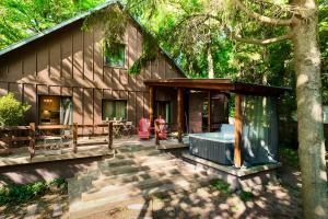 a house with a hot tub in front of it at Spirit of the Earth Cottage Dobogókő in Pilisszentkereszt