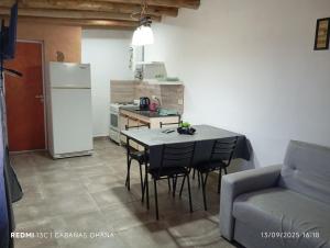 a kitchen with a table and chairs and a refrigerator at Ohana in Potrero de Garay