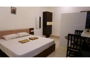 a bedroom with a bed with two platters on it at SHI's 5 Room Stay on Munar Road - Udumalpet in Udumalaippettai