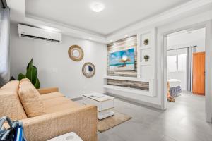 a living room with a couch and a tv at Aruba Comfort Retreat 2br W Pool, Bbq & Gated in Pos Abao