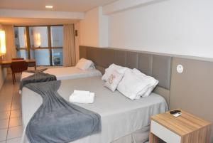 Ένα ή περισσότερα κρεβάτια σε δωμάτιο στο Beira mar - Beach Class Executive 105 +16 φωτογραφίες