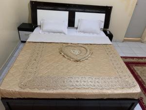 a bedroom with a bed with a bedspread on it at Ndiaye in Nouakchott