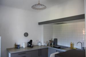 a kitchen with a sink and a counter top at Le Nid - 2 Bedrooms - Myra Conciergerie in Gan